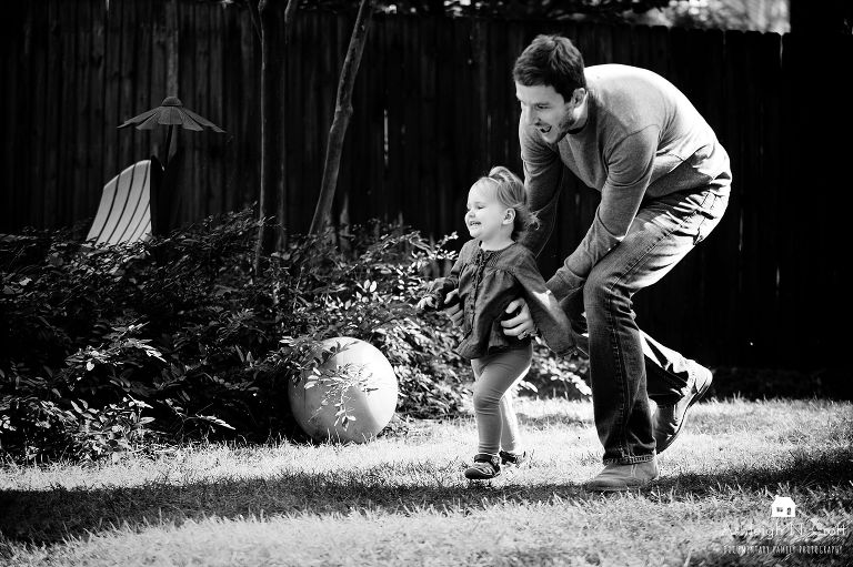 dad chasing daughter in backyard