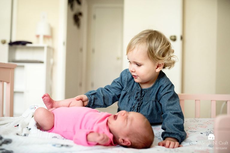 toddler girl and baby sister