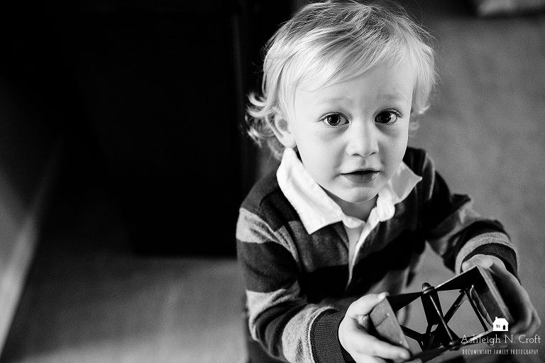 toddler showing off a toy