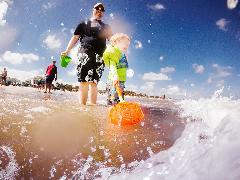 waves splashing boy and father